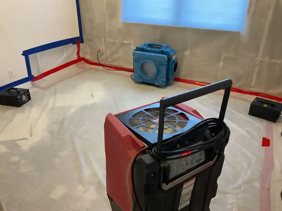 Dehumidification equipment operating within a plastic containment enclosure