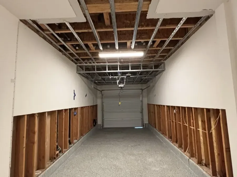 Garage walls with lower drywall removed after a tank leak