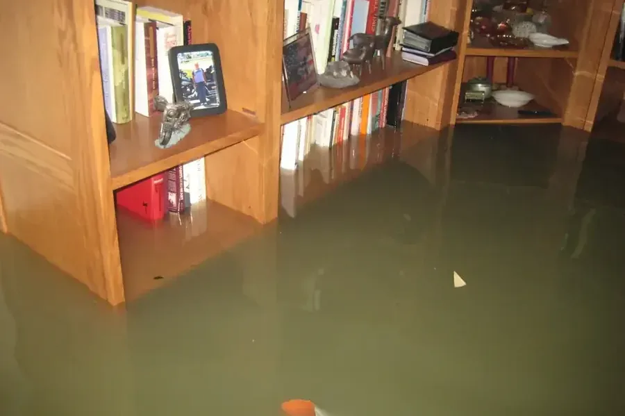 Floodwater covering the floor around living room cabinets